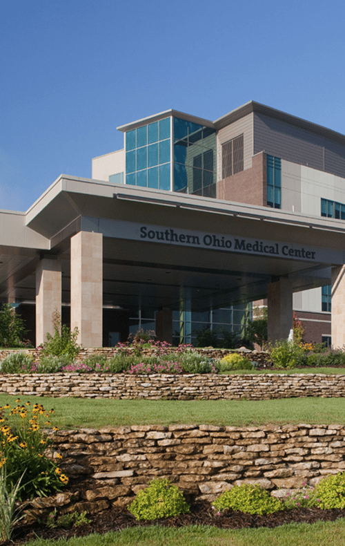 Southern Ohio Medical Center entrance canopy with its name sign above landscaped stone terraces