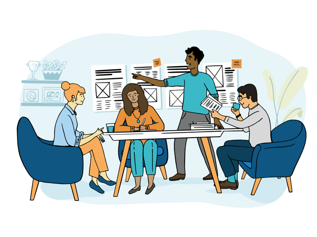 people sitting around table planning layout for newspaper